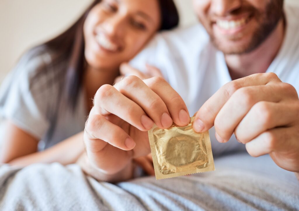 happy-couple-unwraps-a-condom-together