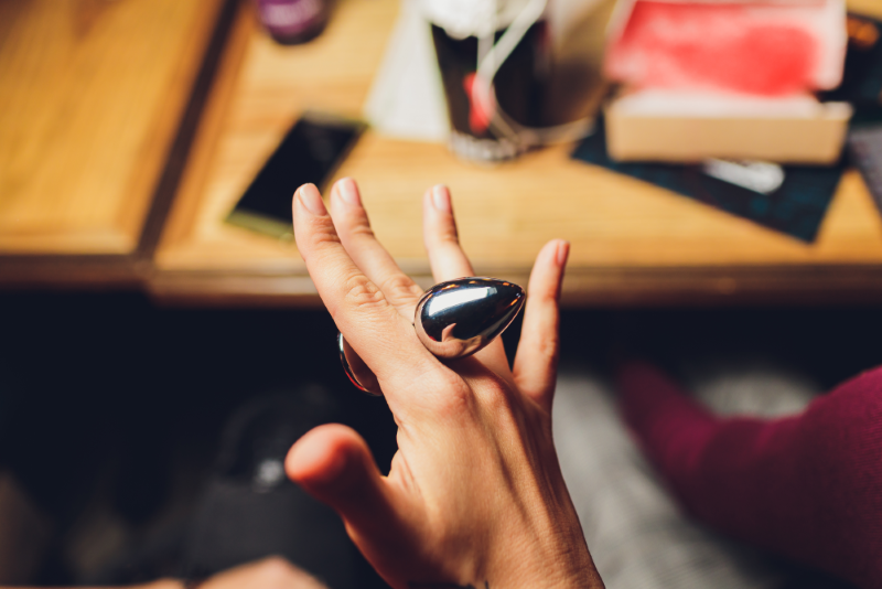 woman-holding-a-fluffy-anal-plug-between-her-fingers.