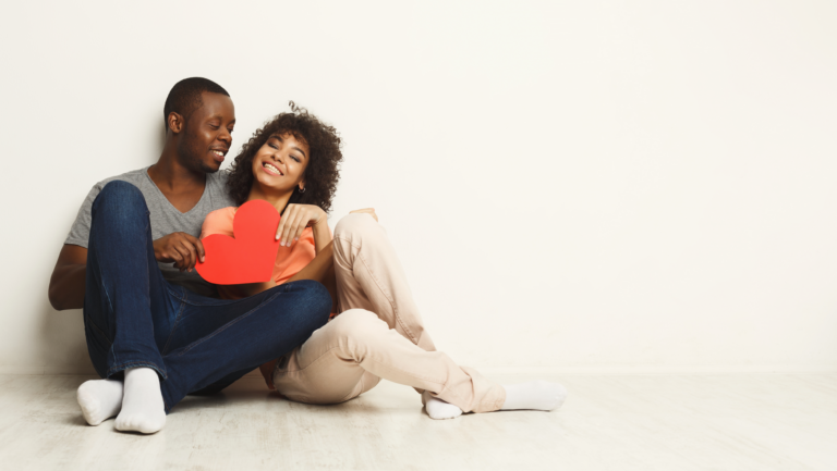 young-happy-african-american-couple-love-holding-paper-hearts-