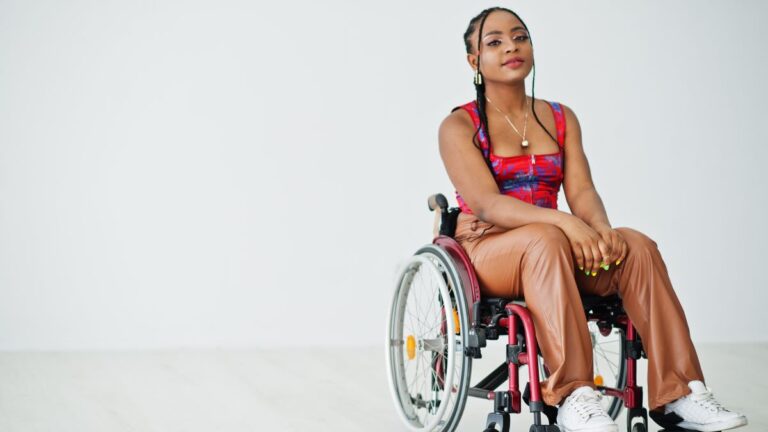 a young Black woman in a wheelchair wearing white running shoes