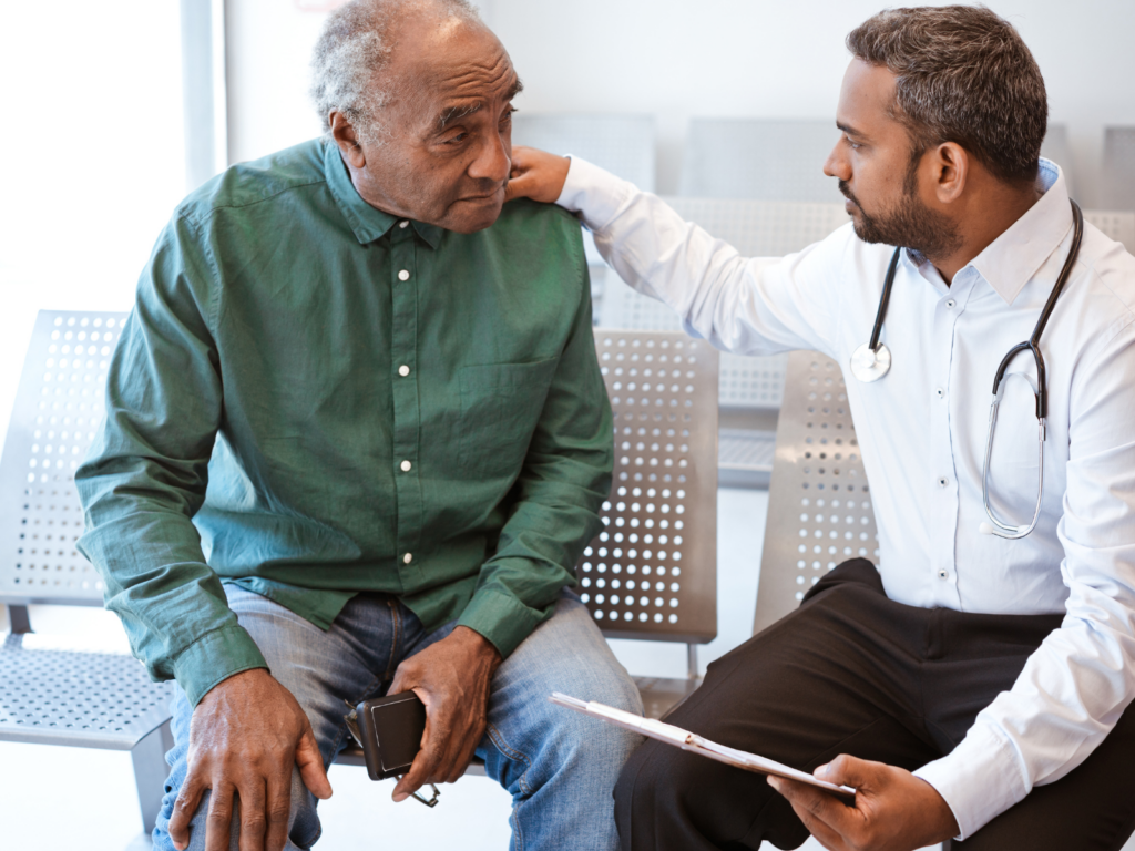 An older man talking to a doctor about his prostate health. 