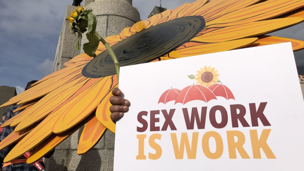 sex work is work sign with yellow sunflower