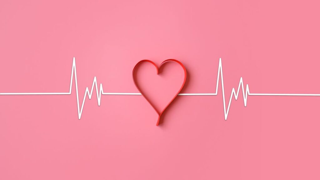 white ecg waves and the outline of a love heart on a pink background