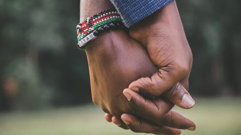 A close up of two hands holding the other