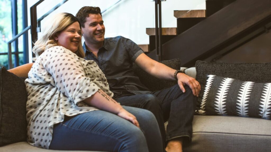 mixed weight white couple on a couch