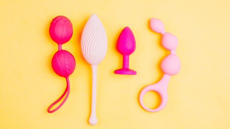 pink sex toys on a yellow background