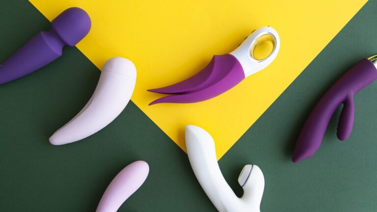 Collection of different types of sex toys on a green and yellow background.