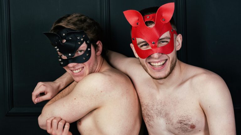 Two topless young men in masks