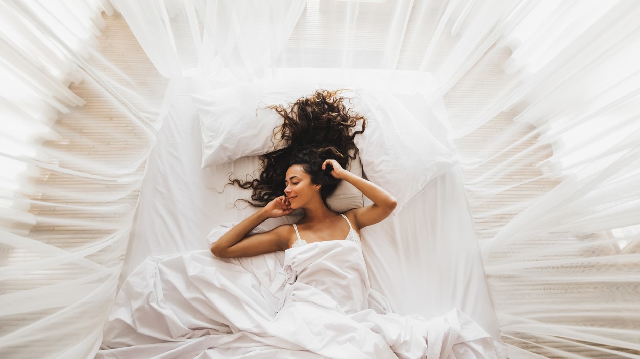 woman lying in bed in pleasure