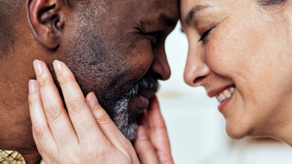 Senior couple smiling with their faces together