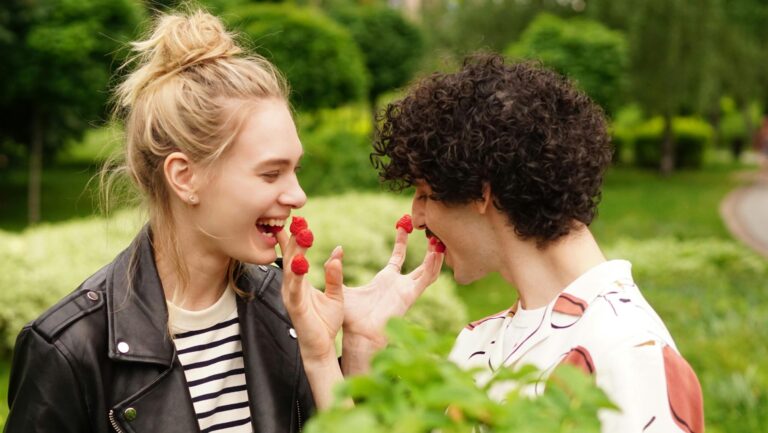 playful neurodivergent couple feeding each other raspberries