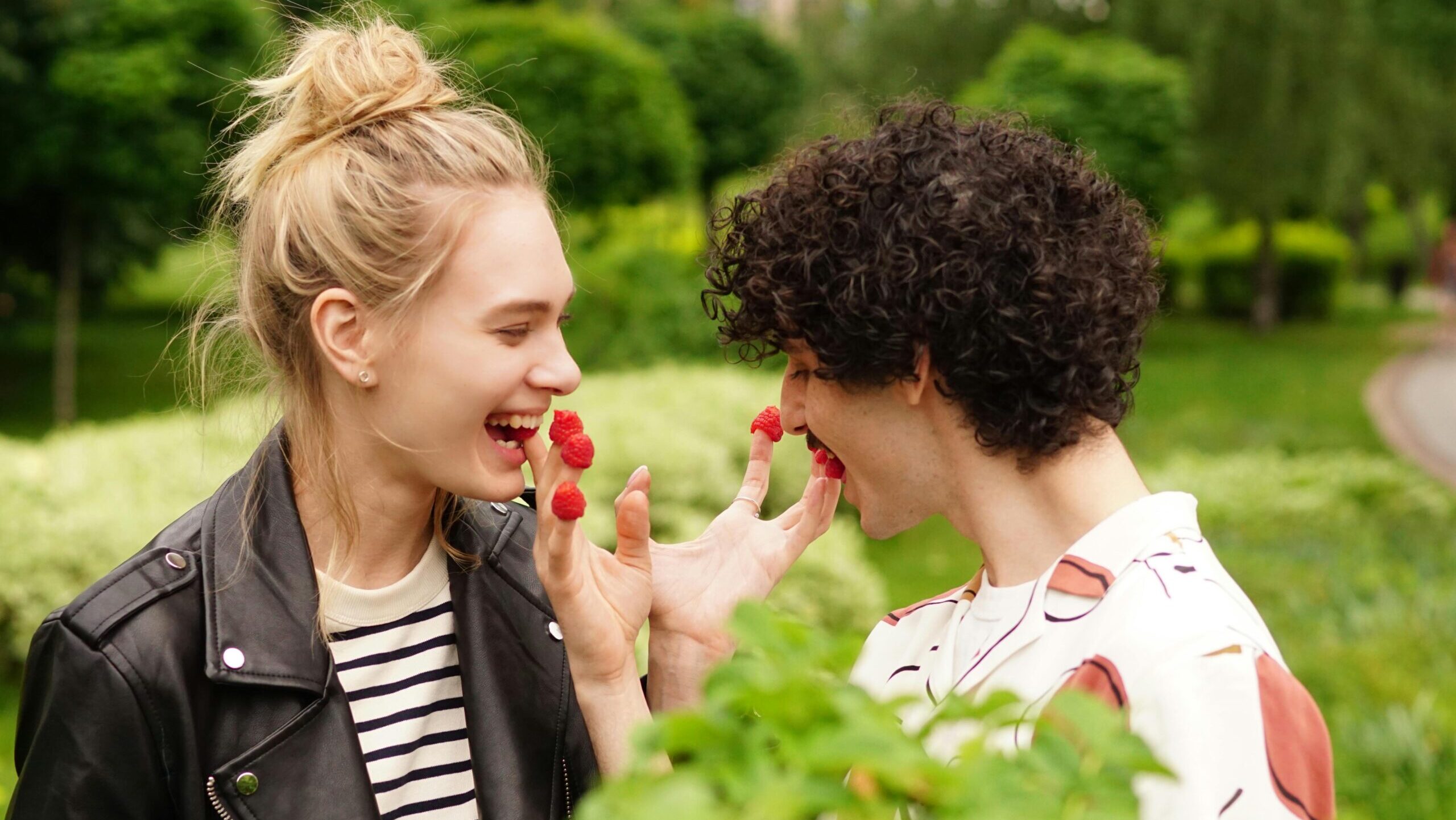 playful neurodivergent couple feeding each other raspberries